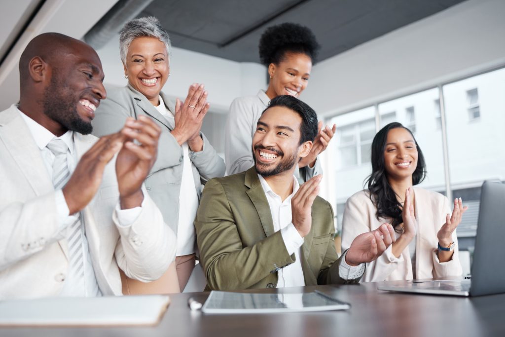 8 astuces pour réussir la mise en place d'une semaine de travail de 4 jours. 5 collaborateurs qui applaudissent